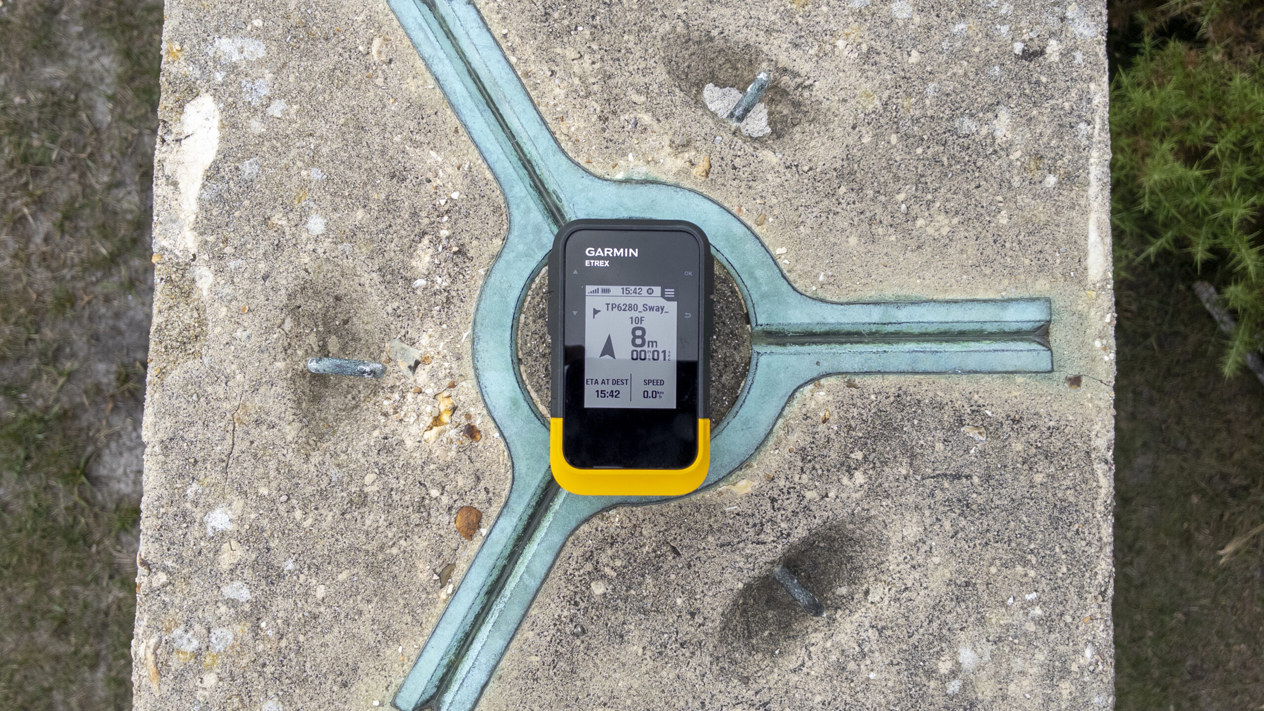 Garmin eTrex SE showing an 8 metre distance to the Sway trig point waypoint while positioned on the trig pillar